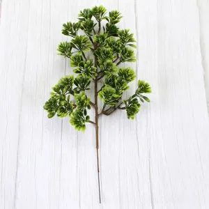 Detailed view of artificial green pine branch with realistic needle clusters