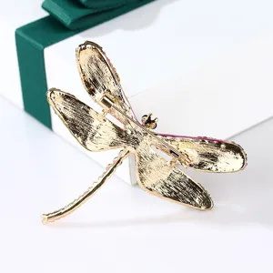Detailed back view of vintage gold dragonfly brooch with secure pin clasp mechanism