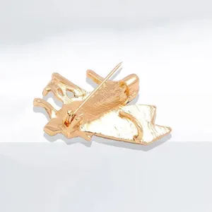 Rear view detail of the gold-plated piano brooch with secure safety pin closure