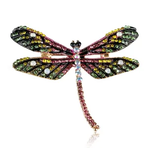Detailed view of colorful dragonfly brooch showing intricate rhinestones and enamel craft