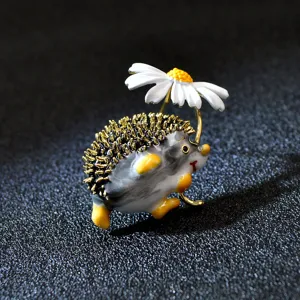 Detailed view of a cute enamel hedgehog brooch holding a white daisy flower charm