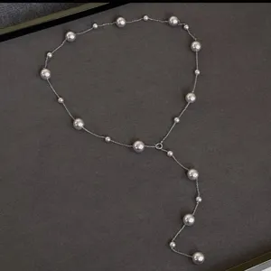 Elegant long Y-shaped station necklace featuring lustrous graduated pearls on silver chain