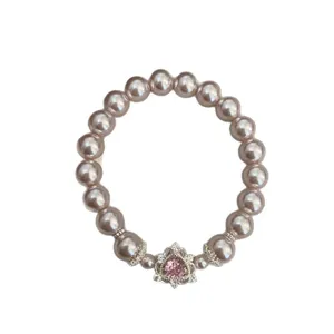 Elegant pink pearl elastic bracelet featuring a sparkling pink heart-shaped zircon pendant.