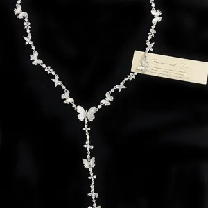 Detailed close-up view of a silver butterfly Y-necklace with shell inlay and zircons.
