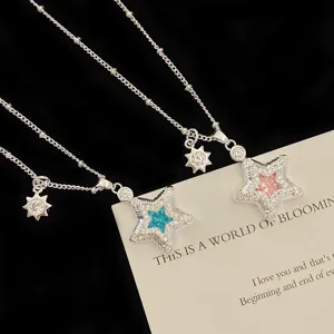 Detail showing micro-set zircon star pendants with blue and pink central crystals