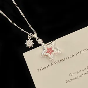 Detailed macro view of silver star pendant necklace with pink zircon and sunflower charm