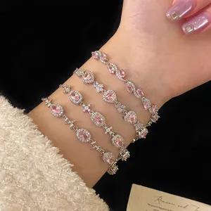 Detailed view of four stacked pink zircon bracelets with heart and floral designs.