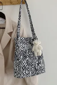 Retro zebra print canvas tote bag featuring a cute white plush bear charm accessory