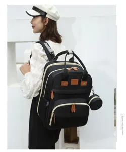 Side view of an Asian model wearing a large black diaper bag with sunshine logo
