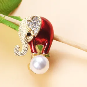 Macro view of elephant brooch with red enamel finish and sparkling rhinestones