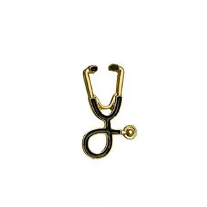 Close-up detail of golden and black stethoscope enamel pin for medical professionals