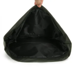 Detailed interior view of roll-top backpack showing spacious black lining and inner pocket