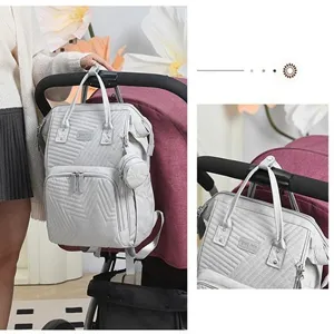 Detailed view of lightweight quilted mummy diaper backpack hanging on stroller with multi pockets.