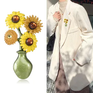 Detail of vintage enamel sunflower brooch in a green vase on a white corduroy blazer.