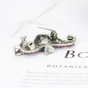 Detailed back view of vintage seahorse brooch with pin mechanism and rhinestones