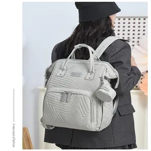 Grey quilted diaper backpack with top handles, large capacity multi-functional travel bag.