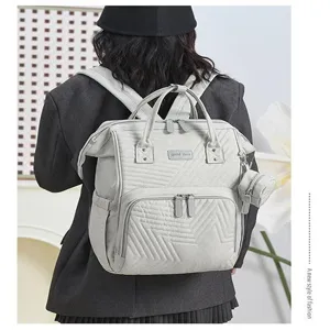 Multifunctional mummy diaper backpack with large capacity, stylish quilted travel bag.