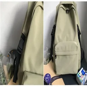 Close-up detail of a minimalist olive green nylon waterproof backpack for students.