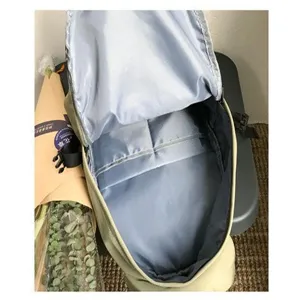 Detail showing the spacious light blue interior with pocket dividers of this nylon backpack