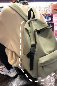 Detailed back view of a minimalist light green nylon waterproof backpack for students
