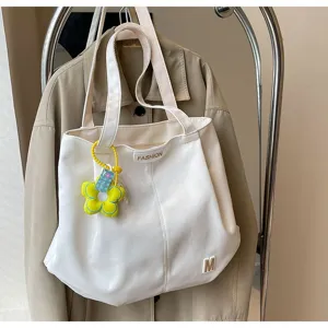 Bolso tote de lona de gran capacidad minimalista para uso diario y estudiantes.