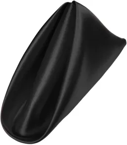 Close-up detail of black satin cloth napkin, smooth fabric texture, elegant hotel table decor.