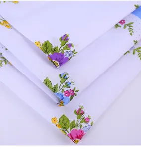 Close-up of cotton floral handkerchief with delicate scalloped edges and colorful prints