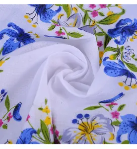 Macro detail of floral printed cotton fabric with delicate blue and pink flowers