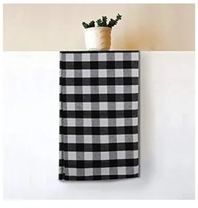 Detailed view of a black and white checkered kitchen tea towel with a classic buffalo plaid pattern