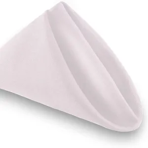 Elegant white satin cloth napkin folded for restaurant hotel table setting and glass wiping.