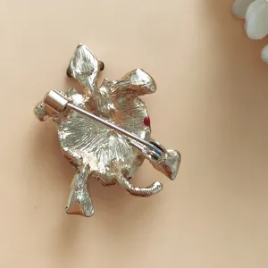 Detailed back view of a gold turtle brooch showing the functional safety pin clasp