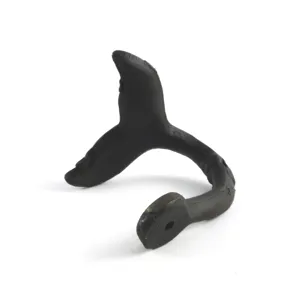 Vintage cast iron whale tail wall hook with a distressed black finish for entryway decor