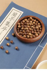 Detailed macro view of high-quality natural brown sandalwood loose beads for DIY jewelry making.