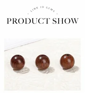 Macro view of three golden silk sandalwood round beads for DIY jewelry making