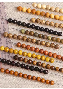 Detailed macro view of various natural wooden beads for DIY jewelry and prayer beads