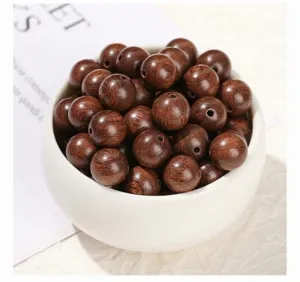 Close-up of natural golden sandalwood beads with rich grain for DIY jewelry making
