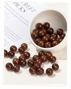 Close-up view of dark brown golden silk sandalwood beads for DIY jewelry making
