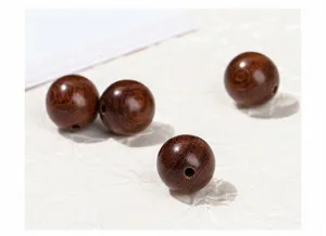 Close-up macro view of natural golden sandalwood round beads with beautiful wood grain texture