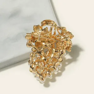 Back view of a gold alloy grape brooch featuring delicate pearls and a secure pin