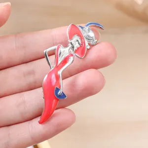 Detailed macro view of elegant modern lady enamel brooch with red hat and crystal