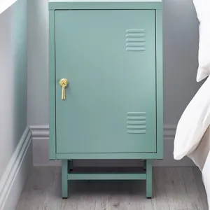 Detailed view of a modern gold cabinet handle installed on a sage green metal locker door