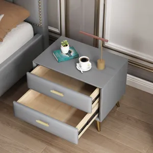 Detailweergave van goudkleurige lineaire handgrepen op moderne grijze nachtkastjes.