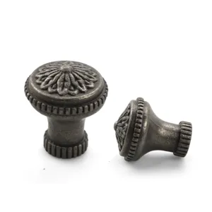 Detailed view of vintage zinc alloy cabinet knobs with floral relief pattern
