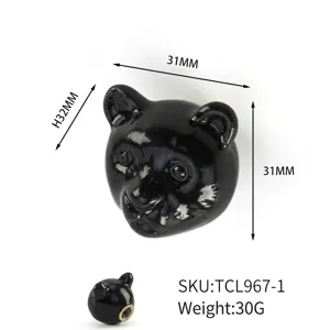 Detailed view of black ceramic bear head drawer handle showing 31x32mm dimensions and SKU