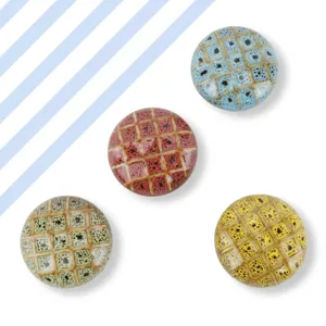 Ceramic cabinet knob detail shot showing colorful grid pattern and speckled glaze finish.