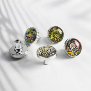 Close-up of decorative cabinet knobs with floral crystal patterns and chrome base.
