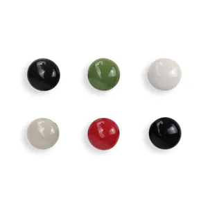 Close-up detail of colorful round ceramic cabinet knobs, smooth glossy surface finish for furniture drawers.