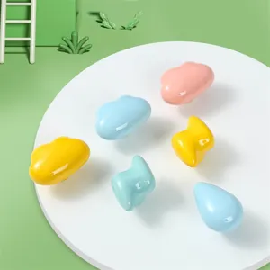 Colorful ceramic cloud and lightning knobs for kids' dresser drawers and cabinets.
