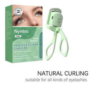 Heated eyelash curler detail view showing USB charging port and ergonomic green handle design.