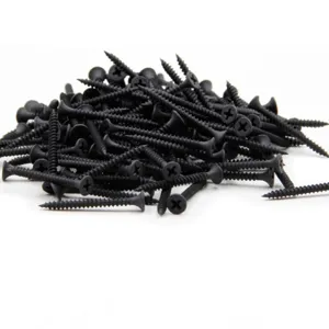 Large pile of black steel countersunk Phillips head self-tapping screws for furniture assembly